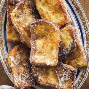 These Traditional Torrijas or Spanish Style French Toasts are homemade and so easy to make. They are creamy on the inside and have a cinnamon sugar coating. Plus, they are the perfect excuse to make the most of stale bread. If you love French toasts, you will love this delicious Spanish Easter dessert. | Paula's Apron Recipe
