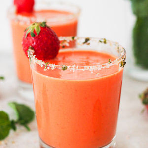 Hot weather calls for no-cook and refreshing recipes, like this Strawberry Gazpacho. It’s quick and easy to put together and a delicious way to use ripe fruit and veggies (or fruit and veggies that don’t look that pretty). It truly tastes absolutely amazing and the salt and mint rimmed glass makes it look even better (and pst! it's naturally vegan, lactose free and can be made gluten-free). | Paula's Apron Recipe